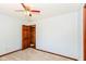 Bedroom with a ceiling fan, neutral carpet, and a wooden door partially open to another room at 3126 Oakmont Dr, Lapel, IN 46051