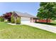 A beautiful garage-side home exterior with a pristine lawn and attractive landscaping at 3126 Oakmont Dr, Lapel, IN 46051