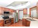 Well-lit kitchen with stainless steel appliances, tile backsplash, and wood cabinets at 3126 Oakmont Dr, Lapel, IN 46051