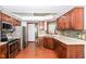 Well-equipped kitchen with stainless steel appliances, wood cabinetry, and granite countertops at 3126 Oakmont Dr, Lapel, IN 46051