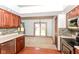 Open kitchen with wood cabinets, stainless appliances, and sliding doors to the backyard at 3126 Oakmont Dr, Lapel, IN 46051