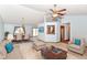 Comfortable living room with ceiling fan, plush furniture, and dining area in the background at 3126 Oakmont Dr, Lapel, IN 46051