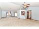 Bright living room with ceiling fan, neutral carpet, and sliding glass door to outdoor space at 3126 Oakmont Dr, Lapel, IN 46051