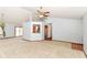 Open living room with ceiling fan, neutral carpet, and view into the dining area at 3126 Oakmont Dr, Lapel, IN 46051