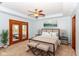 Staged main bedroom with neutral decor, a ceiling fan, and soft carpet at 3126 Oakmont Dr, Lapel, IN 46051