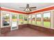 Sunroom featuring brick walls, bright windows, and a view of the fenced backyard at 3126 Oakmont Dr, Lapel, IN 46051