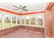 Bright sunroom with brick walls, a ceiling fan, and windows offering backyard views at 3126 Oakmont Dr, Lapel, IN 46051