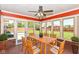 Cozy sunroom featuring large windows, backyard views, and a light wood dining table with seating at 3126 Oakmont Dr, Lapel, IN 46051