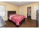 Comfortable bedroom with wood floor, matching furniture, and bright natural light at 320 Red Tail Ln, Indianapolis, IN 46241