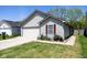 Charming single-story home featuring a well-manicured lawn, attached garage, and delightful curb appeal at 320 Red Tail Ln, Indianapolis, IN 46241