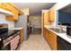 Well-equipped kitchen with stainless steel appliances, warm wood cabinetry, and a view into the dining area at 320 Red Tail Ln, Indianapolis, IN 46241