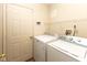 This laundry room features a washer, dryer, and convenient shelving for storage at 320 Red Tail Ln, Indianapolis, IN 46241