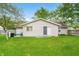 Backyard featuring a lush lawn, patio, mature trees, and well-maintained landscaping at 3334 Old Field Ln, Columbus, IN 47203
