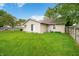 Large backyard with well-maintained lawn, mature trees, and fenced perimeter at 3334 Old Field Ln, Columbus, IN 47203