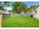 The property features a big grassy backyard with playset, mature trees, and privacy fence at 3334 Old Field Ln, Columbus, IN 47203