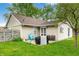 The home features a large, grassy backyard with a patio and mature landscaping at 3334 Old Field Ln, Columbus, IN 47203