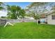 Lush backyard featuring green lawn, mature trees, playset and privacy fence at 3334 Old Field Ln, Columbus, IN 47203