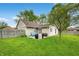 Spacious backyard featuring a patio, mature tree, and a well-maintained lawn at 3334 Old Field Ln, Columbus, IN 47203