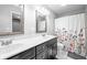 Bathroom features double vanity, framed mirrors, and tub with a decorative shower curtain at 3334 Old Field Ln, Columbus, IN 47203