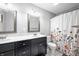 Well-lit bathroom with double sink vanity and shower with decorative curtain at 3334 Old Field Ln, Columbus, IN 47203