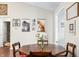 Cozy dining area featuring a wooden table with seating, flowers, and decoratively adorned walls creating a welcoming space at 3334 Old Field Ln, Columbus, IN 47203