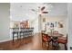 Open-concept dining room with hardwood floors, seating, and kitchen bar, perfect for Gathering gatherings and entertaining at 3334 Old Field Ln, Columbus, IN 47203