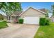 Charming single-story home with a well-maintained lawn and attached two car garage at 3334 Old Field Ln, Columbus, IN 47203