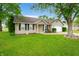 Lovely home featuring mature trees, manicured lawn, an attached garage and welcoming front porch at 3334 Old Field Ln, Columbus, IN 47203