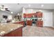 The spacious kitchen features stainless appliances, granite countertops, tile flooring and open to the living area at 3334 Old Field Ln, Columbus, IN 47203