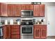 This kitchen features wood cabinets, stainless steel appliances, and elegant granite countertops at 3334 Old Field Ln, Columbus, IN 47203