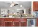 This kitchen features wood cabinets, stainless steel appliances, granite countertops, and updated fixtures at 3334 Old Field Ln, Columbus, IN 47203