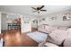 Open-concept living room showcasing hardwood floors, comfortable seating, and decor, seamlessly connected to the kitchen bar at 3334 Old Field Ln, Columbus, IN 47203