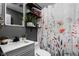 Bathroom with gray vanity, floral shower curtain, and decorative shelving at 3433 Brewer Dr, Indianapolis, IN 46222