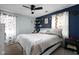 Comfortable bedroom featuring neutral color scheme, ceiling fan, and decor shelf accents at 3433 Brewer Dr, Indianapolis, IN 46222