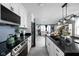 Well-lit kitchen featuring a dark island, white cabinets, and stainless steel appliances at 3433 Brewer Dr, Indianapolis, IN 46222