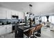 Stylish kitchen with a dark island, white cabinets, and open layout to the living area at 3433 Brewer Dr, Indianapolis, IN 46222