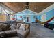Enclosed porch features wood ceiling, sofa, hammock, and outdoor bar at 3433 Brewer Dr, Indianapolis, IN 46222