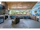 Enclosed porch featuring a wood ceiling, fireplace, and outdoor bar with seating at 3433 Brewer Dr, Indianapolis, IN 46222