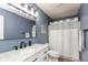 Updated bathroom features modern lighting, vanity with a marble countertop, and blue walls at 35 Valley View, Brownsburg, IN 46112