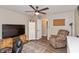 Bedroom with recliner, ceiling fan, hardwood floors, tv, and neutral paint at 35 Valley View, Brownsburg, IN 46112