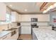 A kitchen featuring white cabinets, stainless appliances, and a large granite island at 35 Valley View, Brownsburg, IN 46112