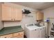 Functional laundry room with overhead cabinets, a folding counter, and a washer/dryer at 35 Valley View, Brownsburg, IN 46112