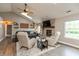 Bright living room with hardwood floors, brick fireplace, and comfortable seating at 35 Valley View, Brownsburg, IN 46112
