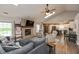 Open-concept living room featuring a brick fireplace and seamless flow to the adjacent kitchen at 35 Valley View, Brownsburg, IN 46112