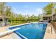 Stunning backyard featuring a large pool, diving board, and an adjacent lounge area with chairs at 35 Valley View, Brownsburg, IN 46112