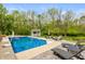 Beautiful backyard pool area surrounded by landscaping and lounge chairs at 35 Valley View, Brownsburg, IN 46112