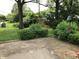 A brick patio in a lush backyard with mature trees and a glimpse of a play area at 3619 31St St, Columbus, IN 47203