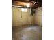Unfinished basement featuring block walls, a small window, and accessible electrical panel at 3619 31St St, Columbus, IN 47203