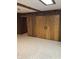 Basement area with neutral carpet, wood paneling, and ample storage space at 3619 31St St, Columbus, IN 47203
