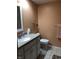 Functional bathroom with a white vanity, toilet, granite counters, and light-brown walls at 3619 31St St, Columbus, IN 47203